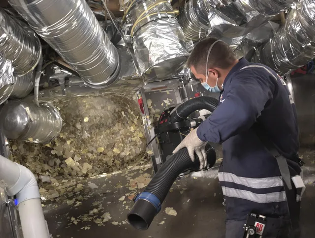 Acushnet Air Duct Cleaning specialist operating negative pressure cleaning equipment for thorough duct maintenance in Acushnet