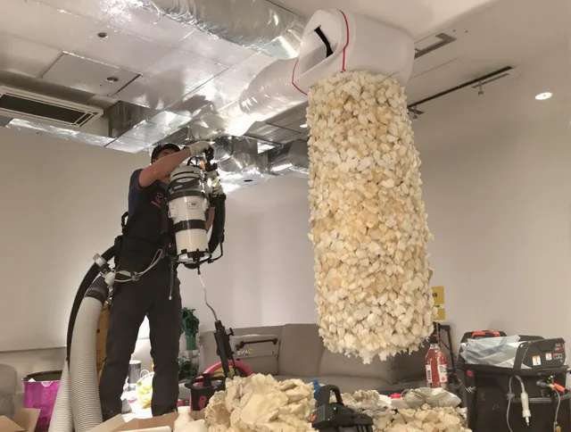 Acushnet Air Duct Cleaning technician performing precision vacuum insulation removal in a residential property in Acushnet